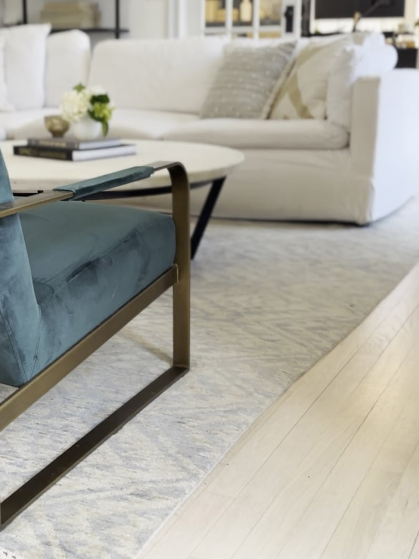 Dad pushing Daughter in Cardboard box on Hardwood Floors in Home.